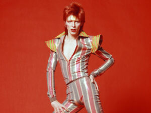 David Bowie descended from Freya on the Soul Tree - photo of the rock artist David Bowie from his ziggy stardust era against a red background.