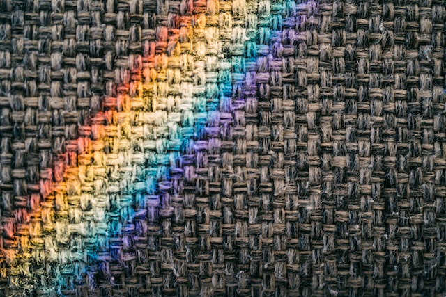 Image of woven fabric with a rainbow motif.