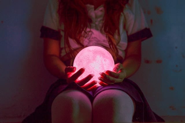 What is a soul? Woman holding a glowing sphere of light.