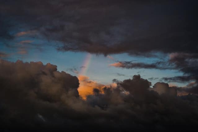 What to do during the Dark Night of the Soul: rainbow showing through storm clouds.