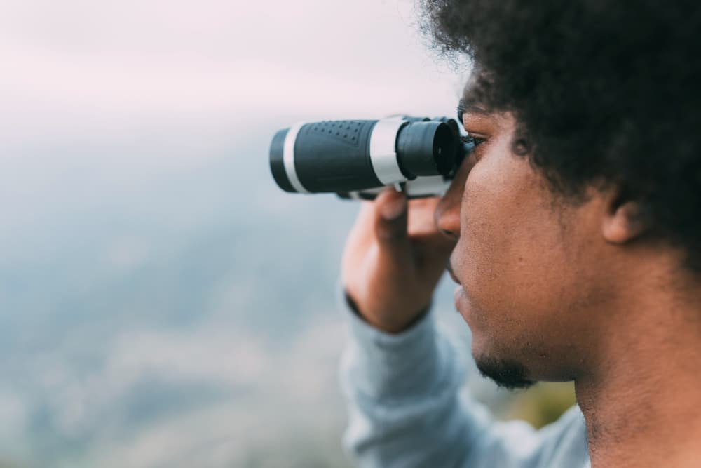 How to find my life purpose: man looking through binoculars.