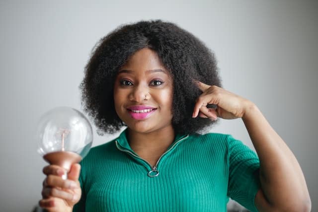 Woman holding a light bulb.