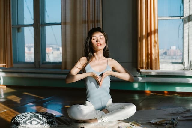 Woman meditating with a crystal.