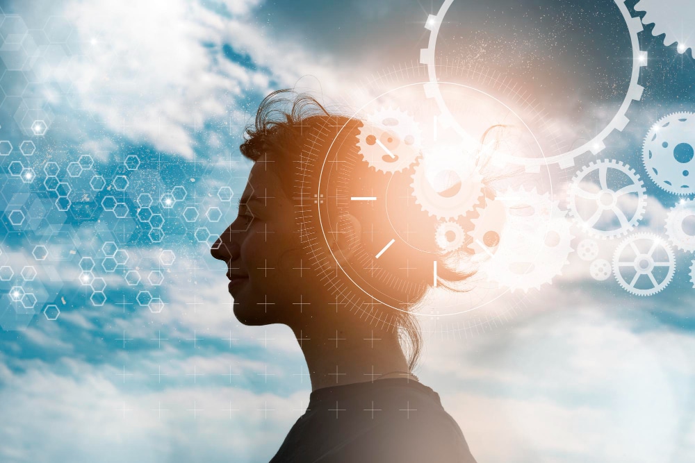 what is spiritual awakening - woman in silhouette with cogs and gears superimposed on her head.