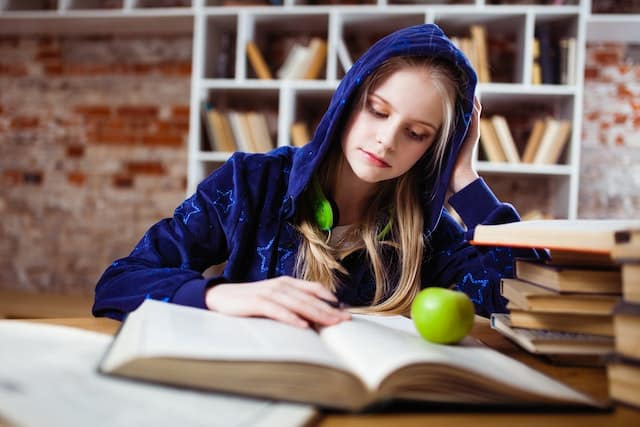 Spiritual awakening stage 2 Discovery - young woman studying books.