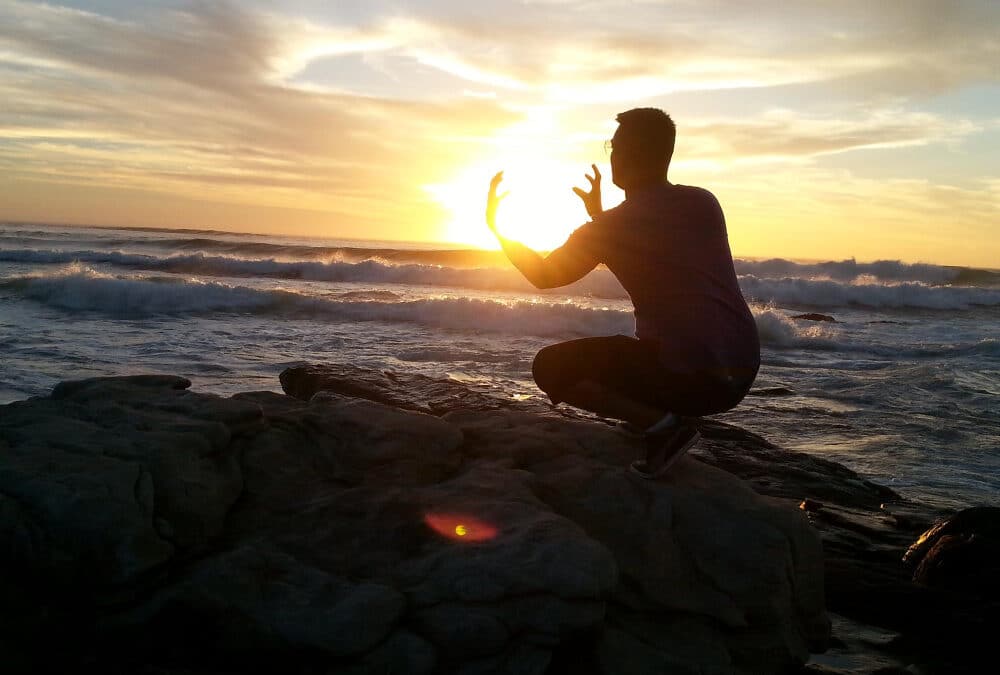 Spiritual Seeker: man looking like he's holding the sun.