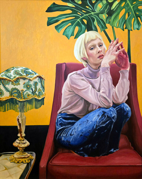Contemporary portrait - colourful painting of a young woman squatting on a red armchair, with an ornate lamp to the left and a large plant behind her. She is wearing blue velvet trousers and a lilac jumper.
