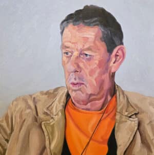 Contemporary portrait in oils: a painting of a man wearing a beige jacket and an orange t-shirt.