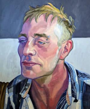 Contemporary portrait in oils. Head and shoulders of a man in three quarter view, wearing a blue checked shirt.